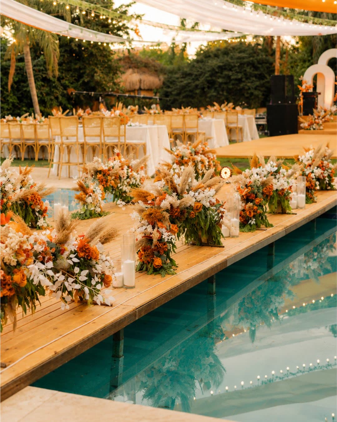 Poolside aisle lined with flowers